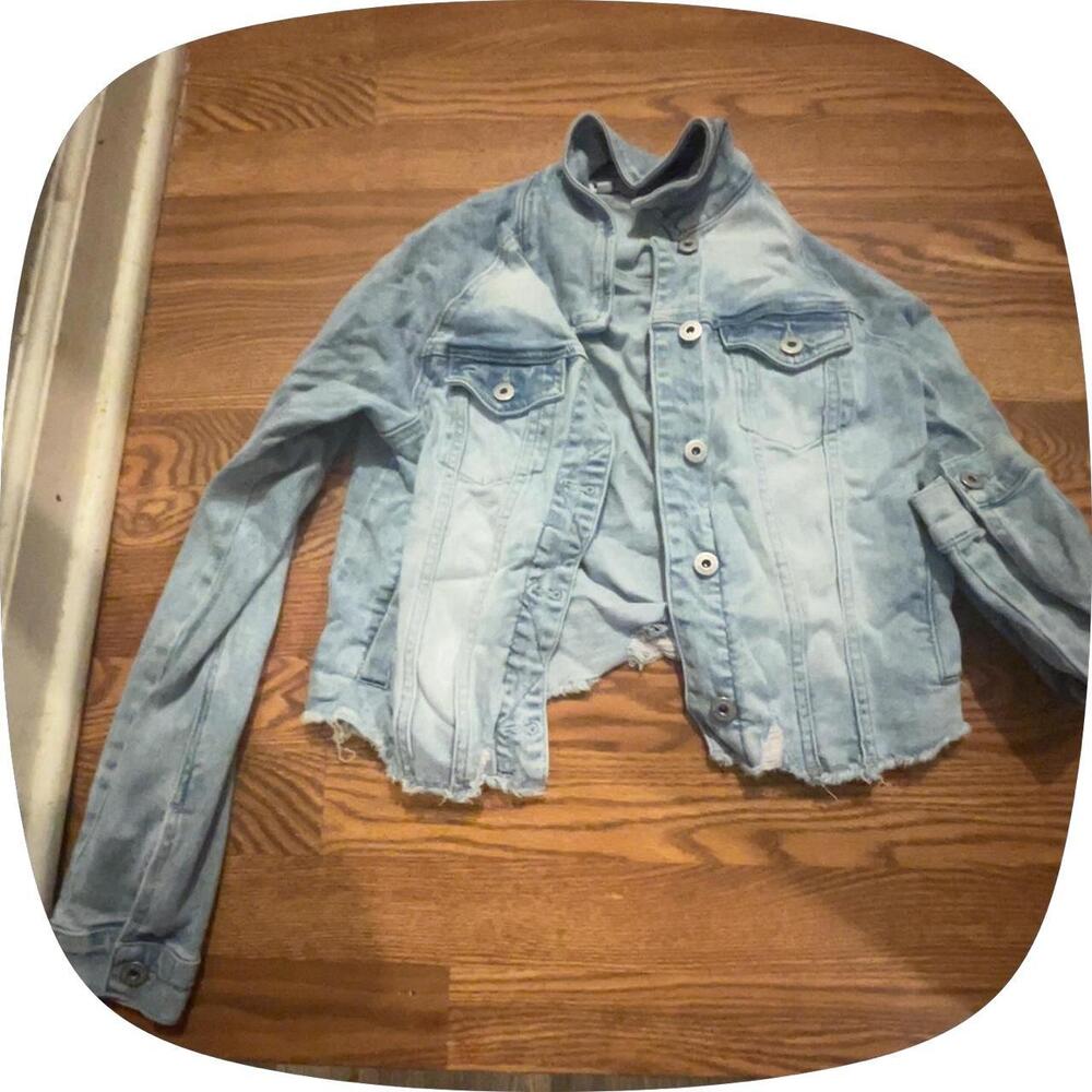 Light blue denim jacket with a distressed look, size XS sorry for the wrinkle wi
